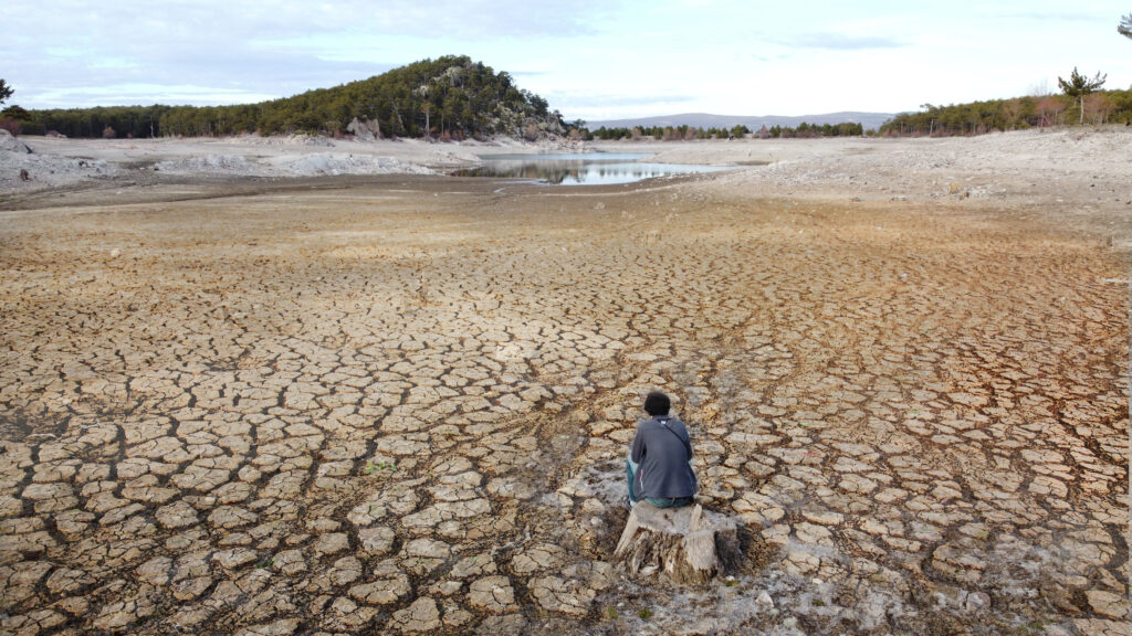 man in a dried up lake